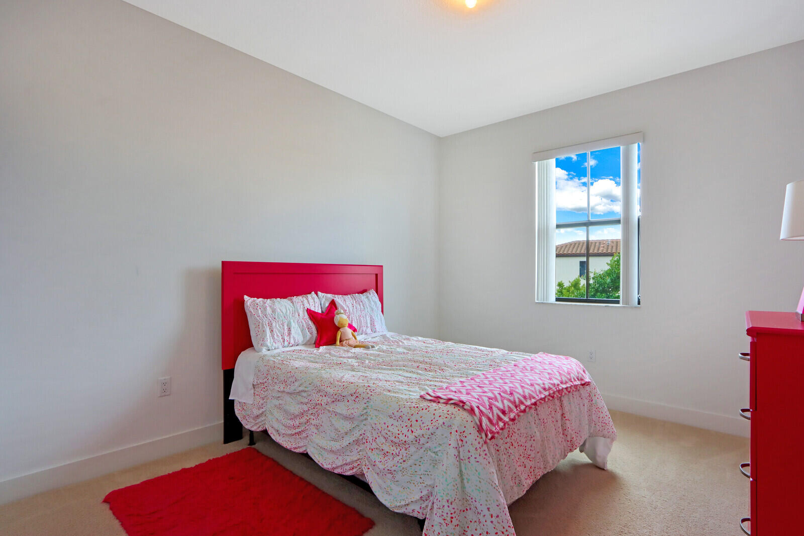 6024 Pine Tree Way Riviera Beach, FL 33410 - Photo 16 of 26 a bedroom with a bed a dresser and a window