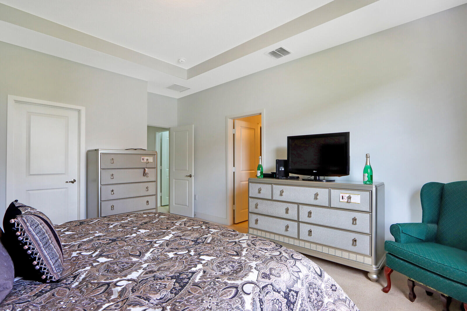 6024 Pine Tree Way Riviera Beach, FL 33410 - Photo 19 of 26 a bedroom with a bed and flat screen tv