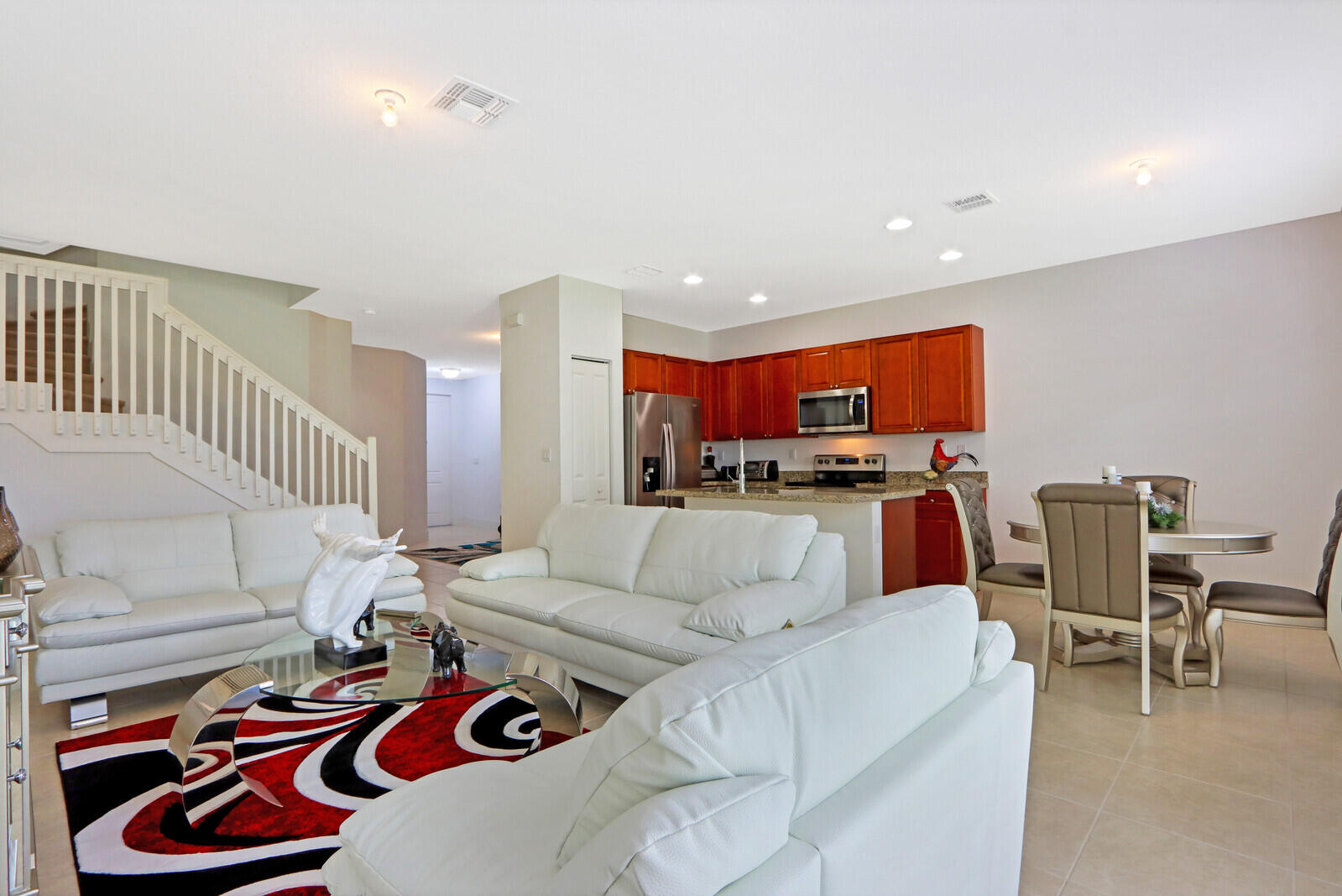 6024 Pine Tree Way Riviera Beach, FL 33410 - Photo 6 of 26 a living room with furniture kitchen view and a table