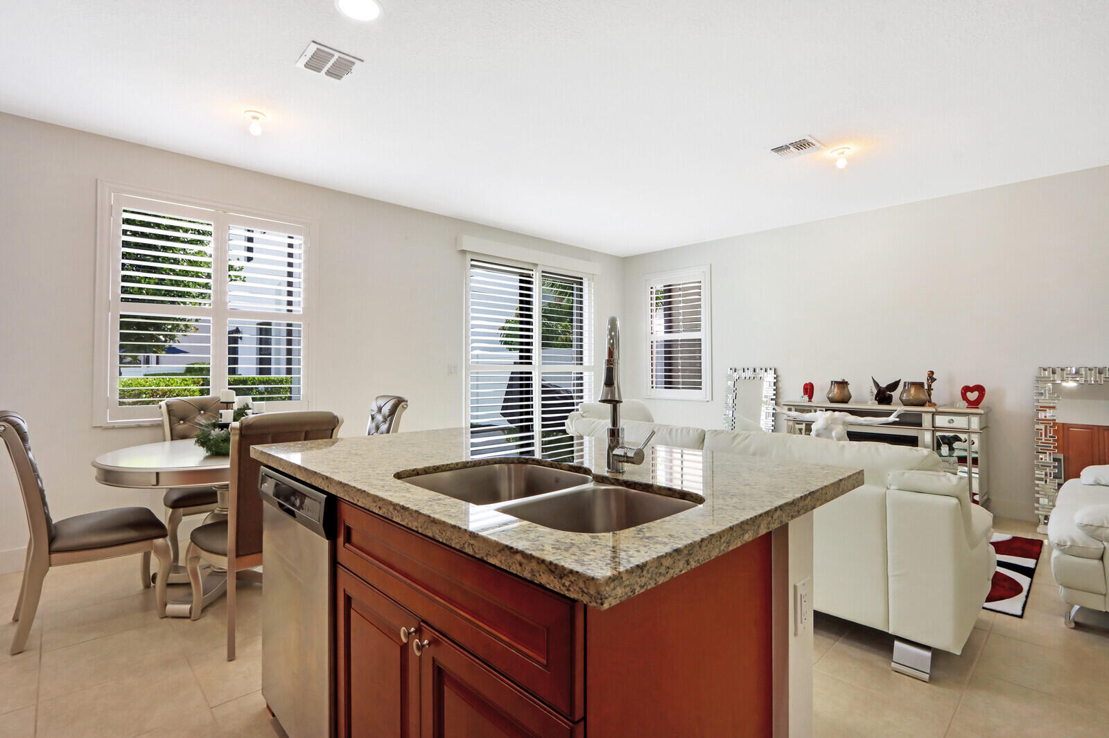 6024 Pine Tree Way Riviera Beach, FL 33410 - Photo 9 of 26 a kitchen that has a sink and chairs in it