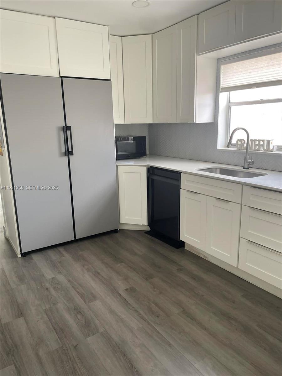 Sandalfoot Cove Boca Raton, FL 33428 - Photo 2 of 12 a kitchen with stainless steel appliances granite countertop a sink and a refrigerator