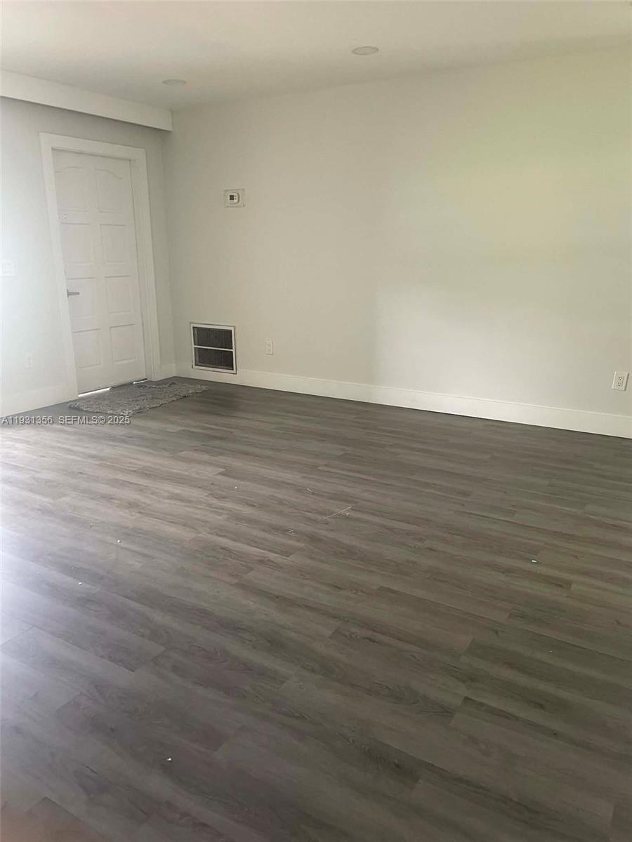 Sandalfoot Cove Boca Raton, FL 33428 - Photo 10 of 12 a view of an empty room with wooden floor