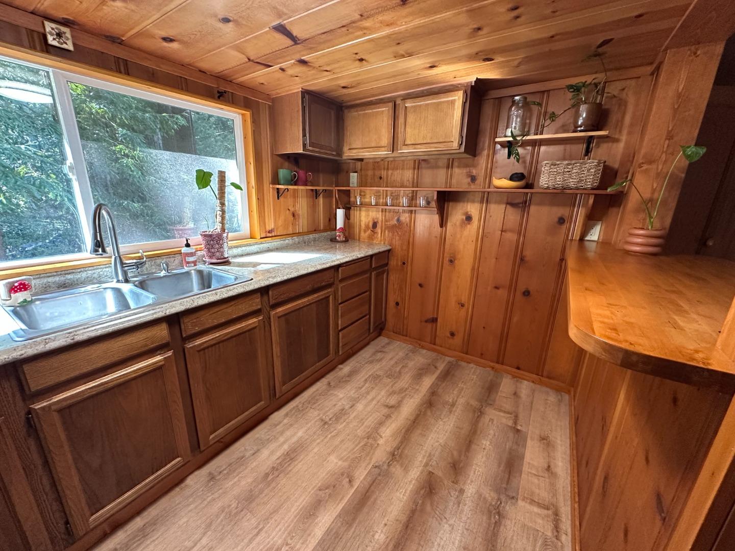 155 McGaffigan Mill Road Boulder Creek, CA 95006 - Photo 8 of 23 a kitchen with a sink and wooden cabinets