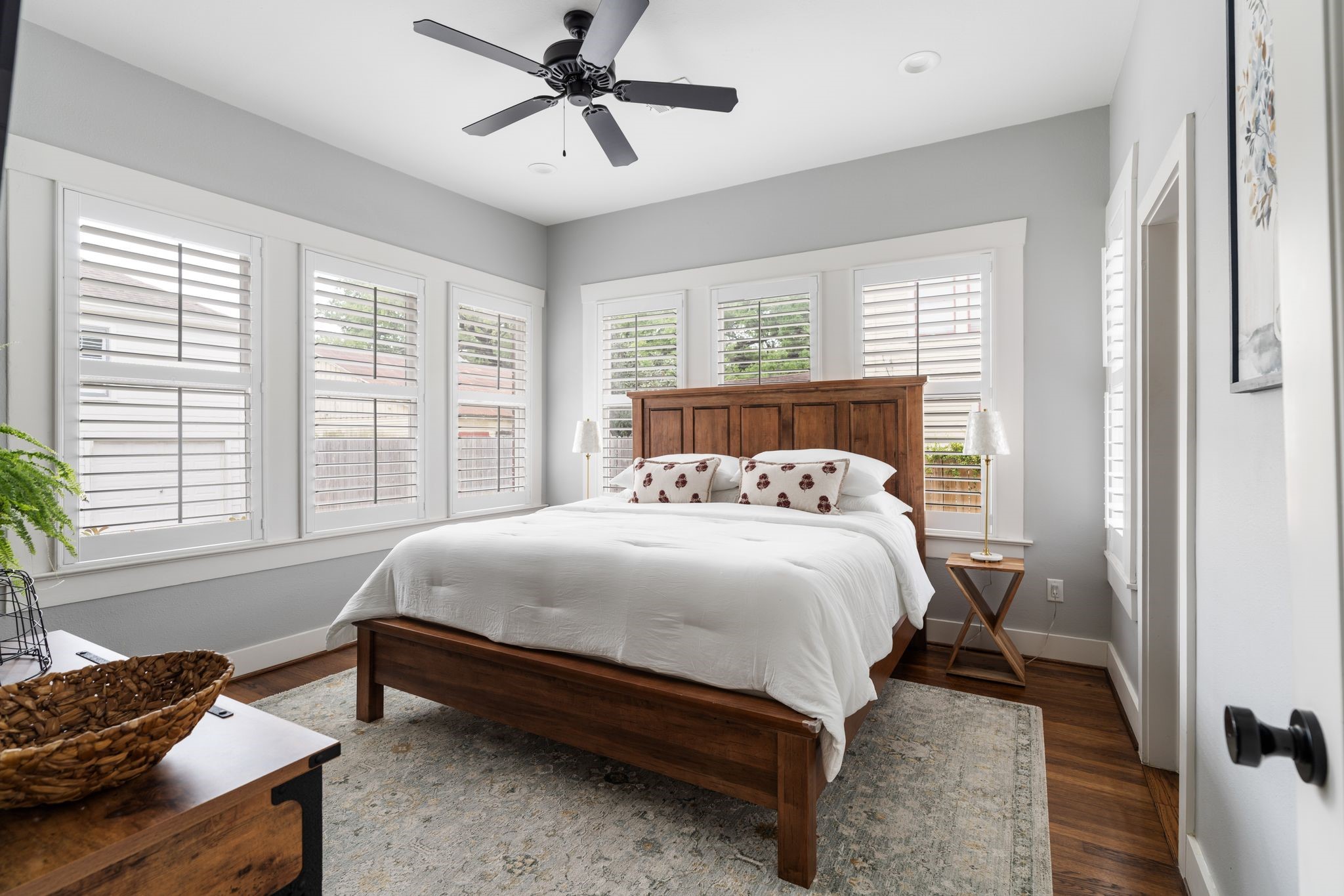 3206 Morrison Street Houston, TX 77009 - Photo 12 of 30 The primary bedroom is a true retreat, featuring oversized windows, plantation shutters for added privacy, and a walk-in closet complete with a built-in dresser.