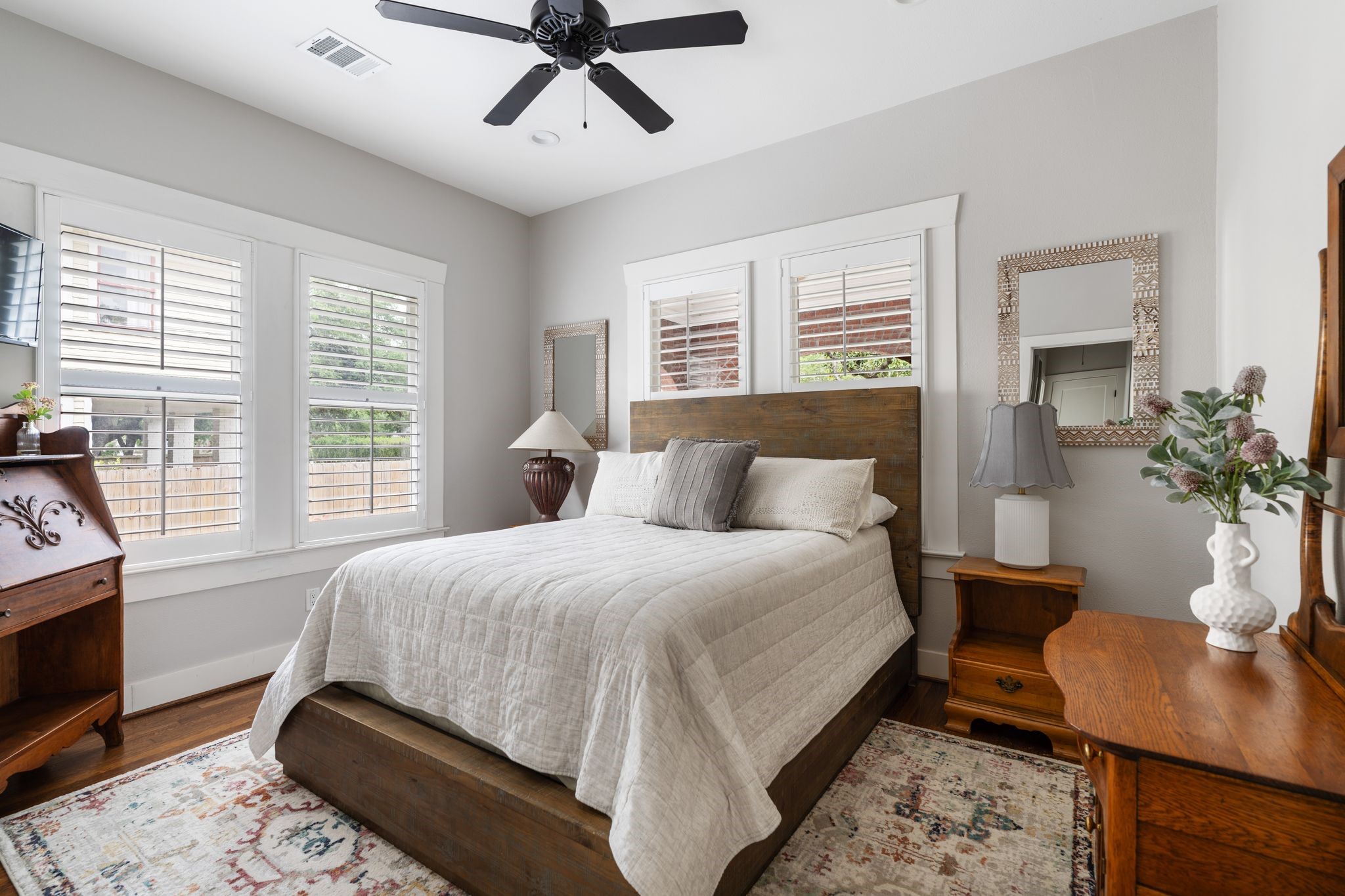 3206 Morrison Street Houston, TX 77009 - Photo 16 of 30 Another generous secondary bedroom bathed in natural light from its windows, framed by classic plantation shutters.