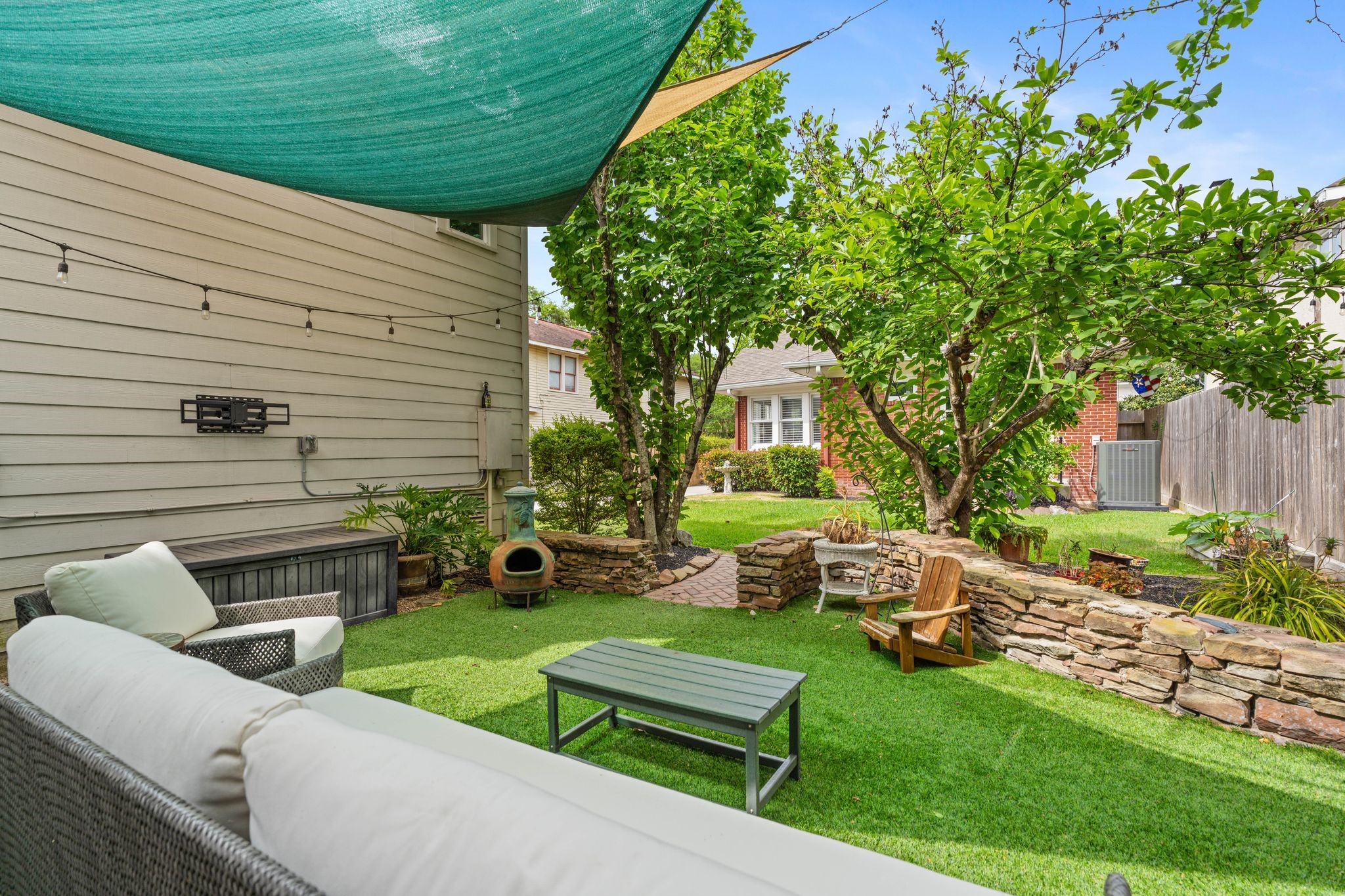 3206 Morrison Street Houston, TX 77009 - Photo 22 of 30 Lush turf, twinkling string lights, sun sails for shade, TV mount, and electrical connections are ready for all your outdoor entertainment needs.