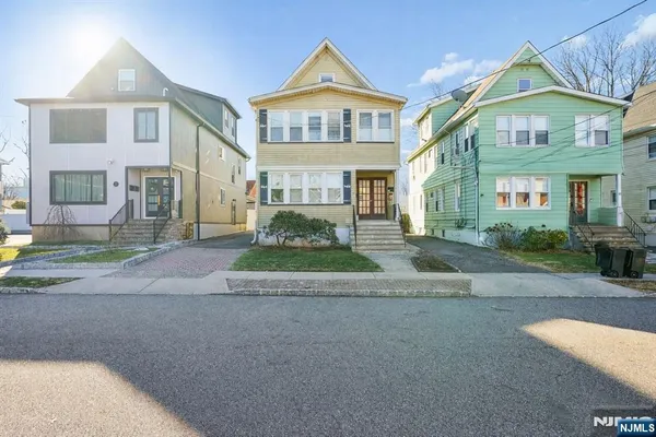 a view of a big house with a street