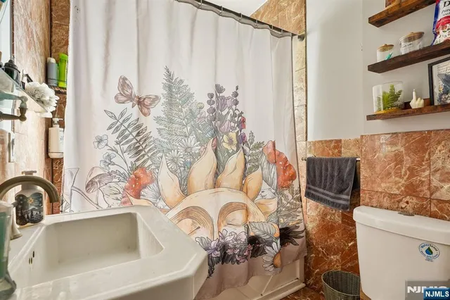 a bathroom with a sink a toilet and a mirror