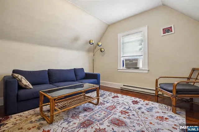 a living room with a couch and a rug