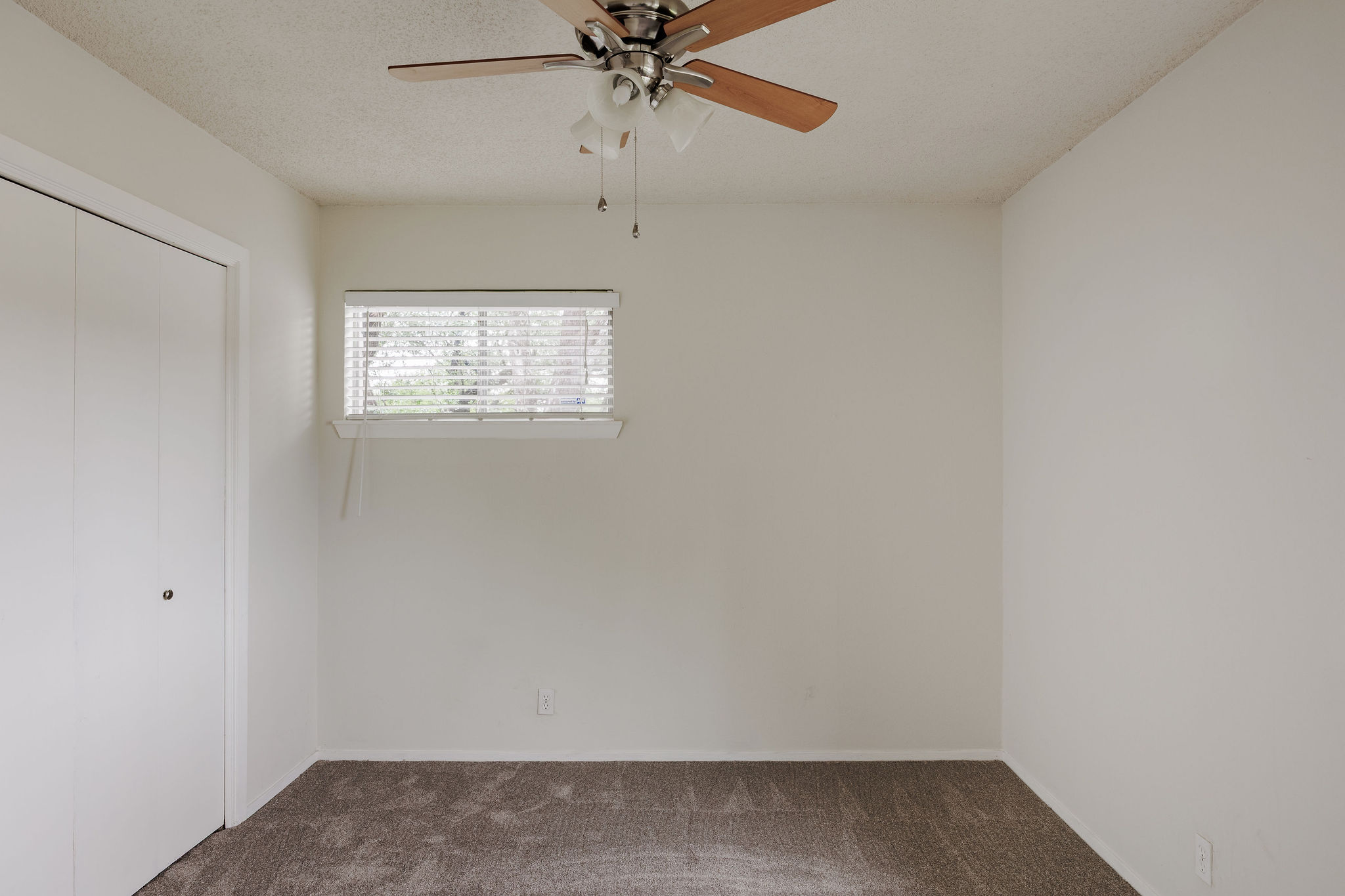 2012 Cody Court Austin, TX 78704 - Photo 28 of 40 A well-lit bedroom with soft carpeting and a functional ceiling fan.