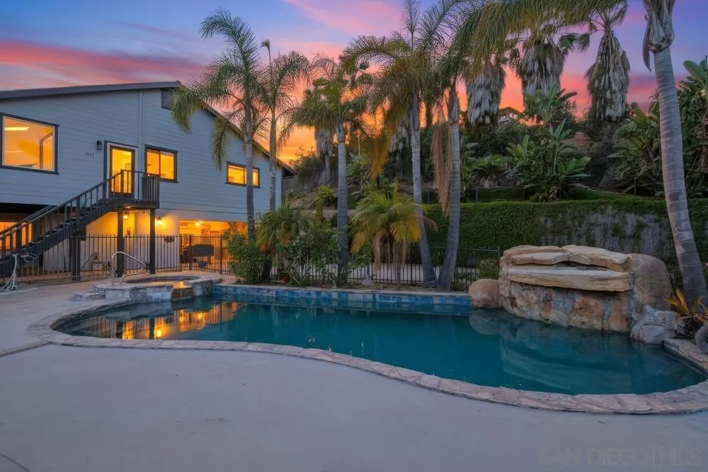 a swimming pool with outdoor seating and yard