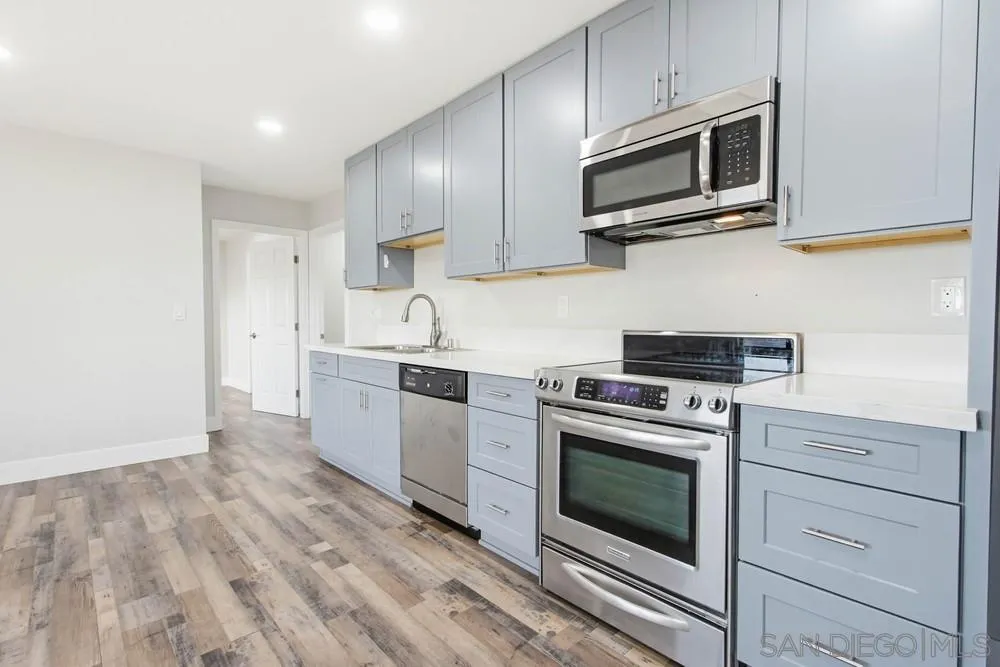 25147 Jack Rabbit Acres, Unit 2 Escondido, CA 92026 - Photo 11 of 39 a kitchen with stainless steel appliances granite countertop a stove a microwave and cabinets