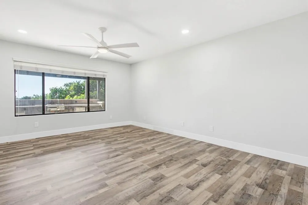 25147 Jack Rabbit Acres, Unit 2 Escondido, CA 92026 - Photo 12 of 39 an empty room with wooden floor fan and windows