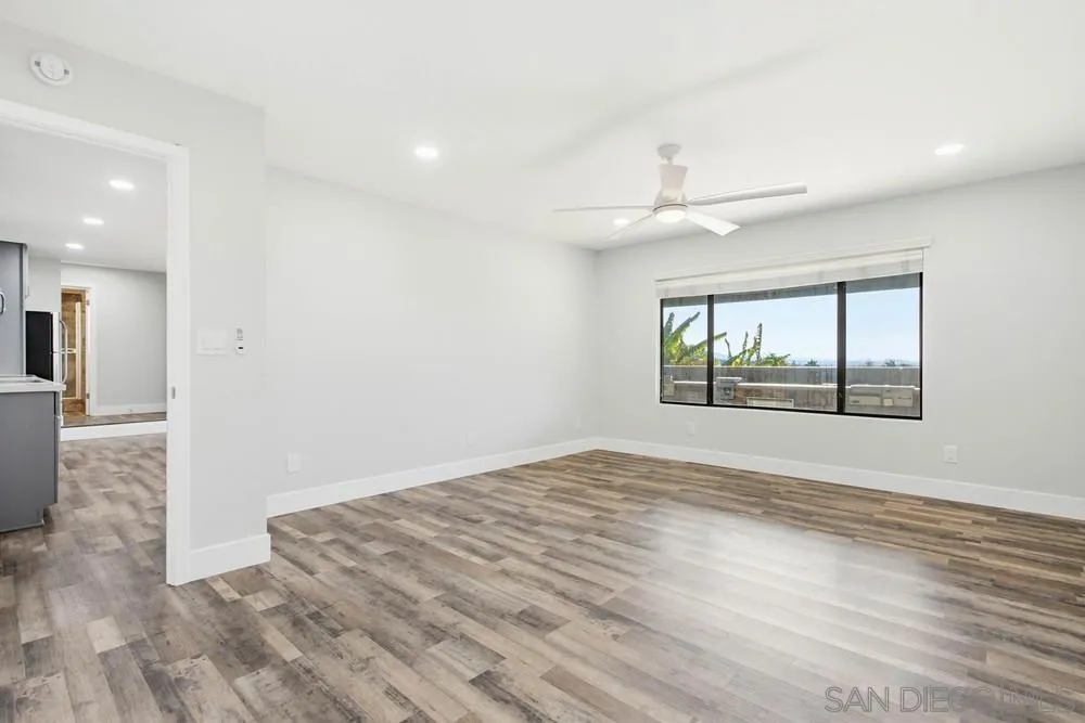 25147 Jack Rabbit Acres, Unit 2 Escondido, CA 92026 - Photo 13 of 39 an empty room with wooden floor and windows