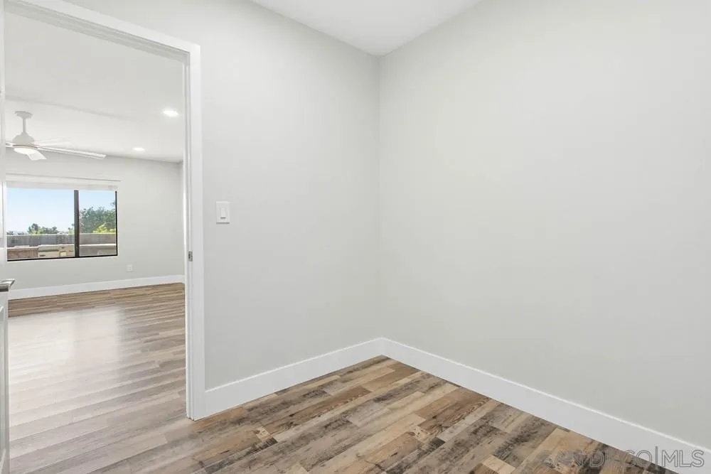 25147 Jack Rabbit Acres, Unit 2 Escondido, CA 92026 - Photo 17 of 39 an empty room with wooden floor and mirror