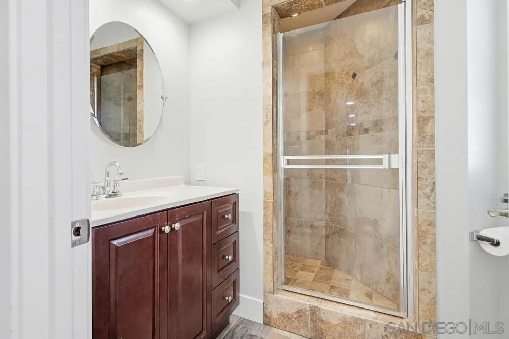 25147 Jack Rabbit Acres, Unit 2 Escondido, CA 92026 - Photo 18 of 39 a bathroom with a sink a mirror and a shower