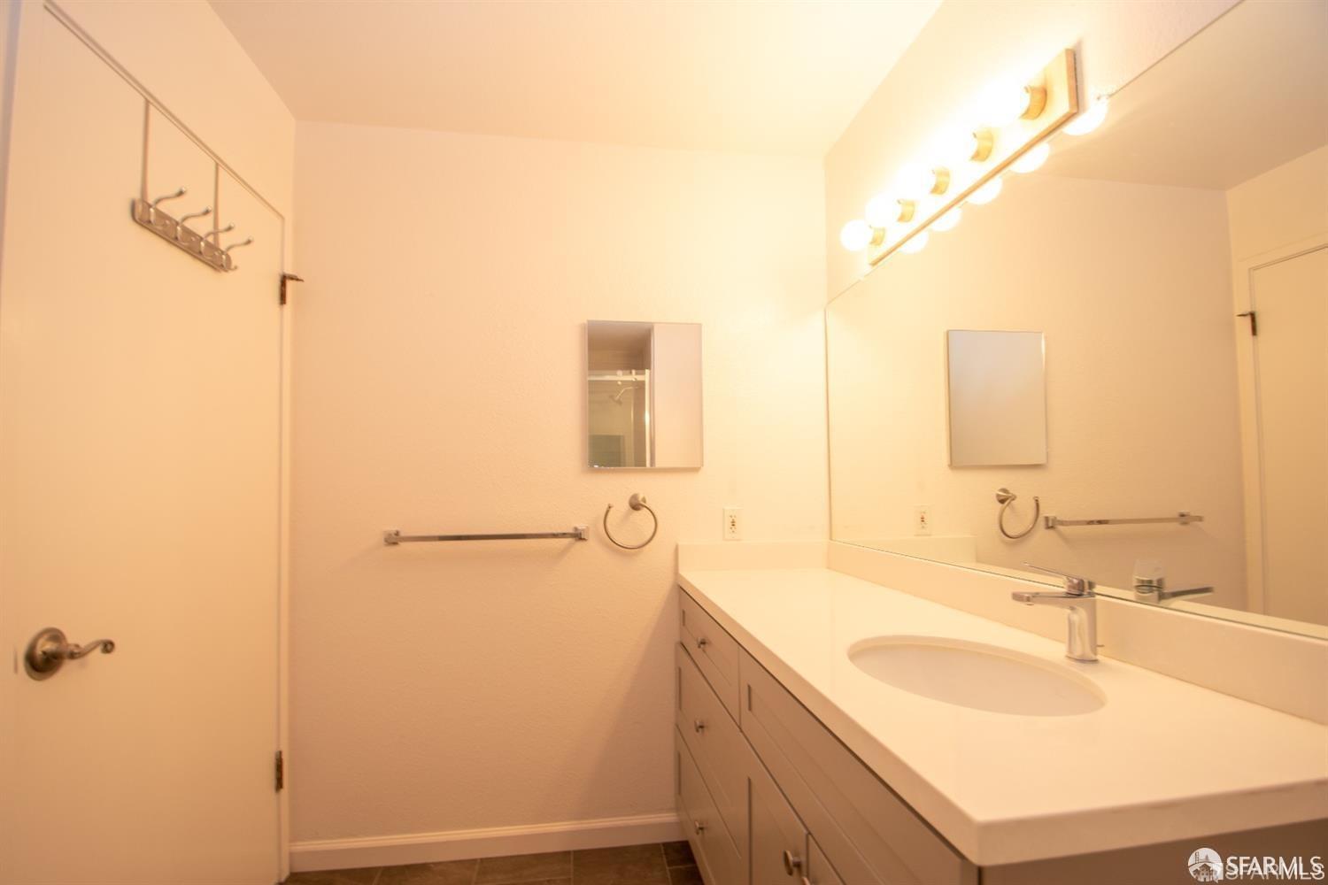 2225 23rd Street, Unit 111 San Francisco, CA 94107 - Photo 16 of 18 a bathroom with a sink and a mirror
