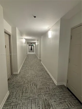 a view of hallway with wooden floor