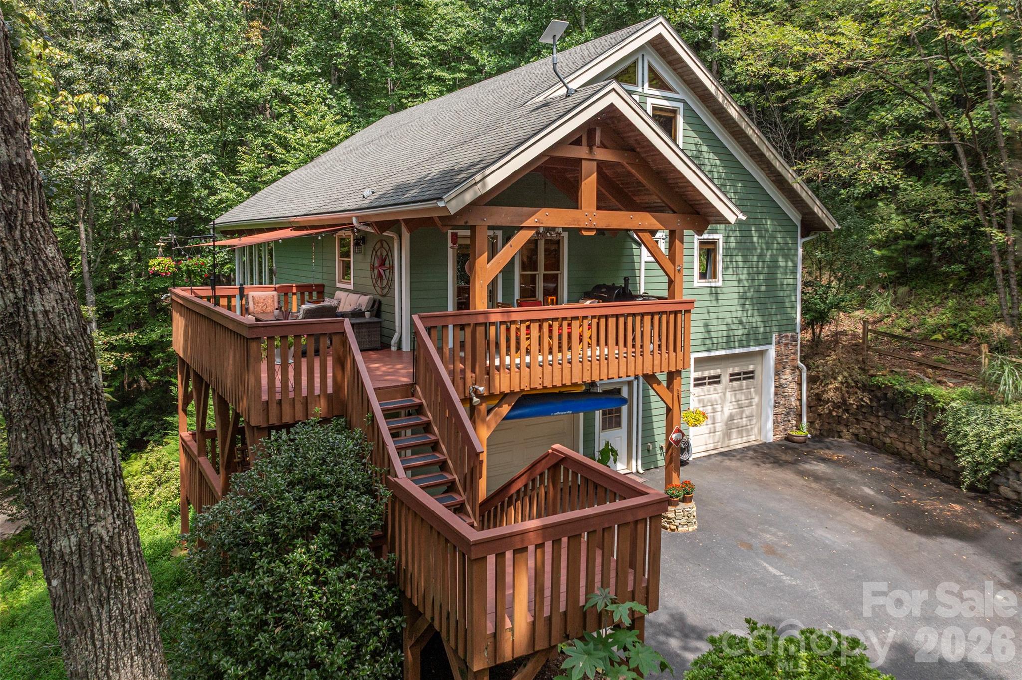 116 Ivy Road Mills River, NC 28759 - Photo 1 of 45 a front view of a house with garden and deck