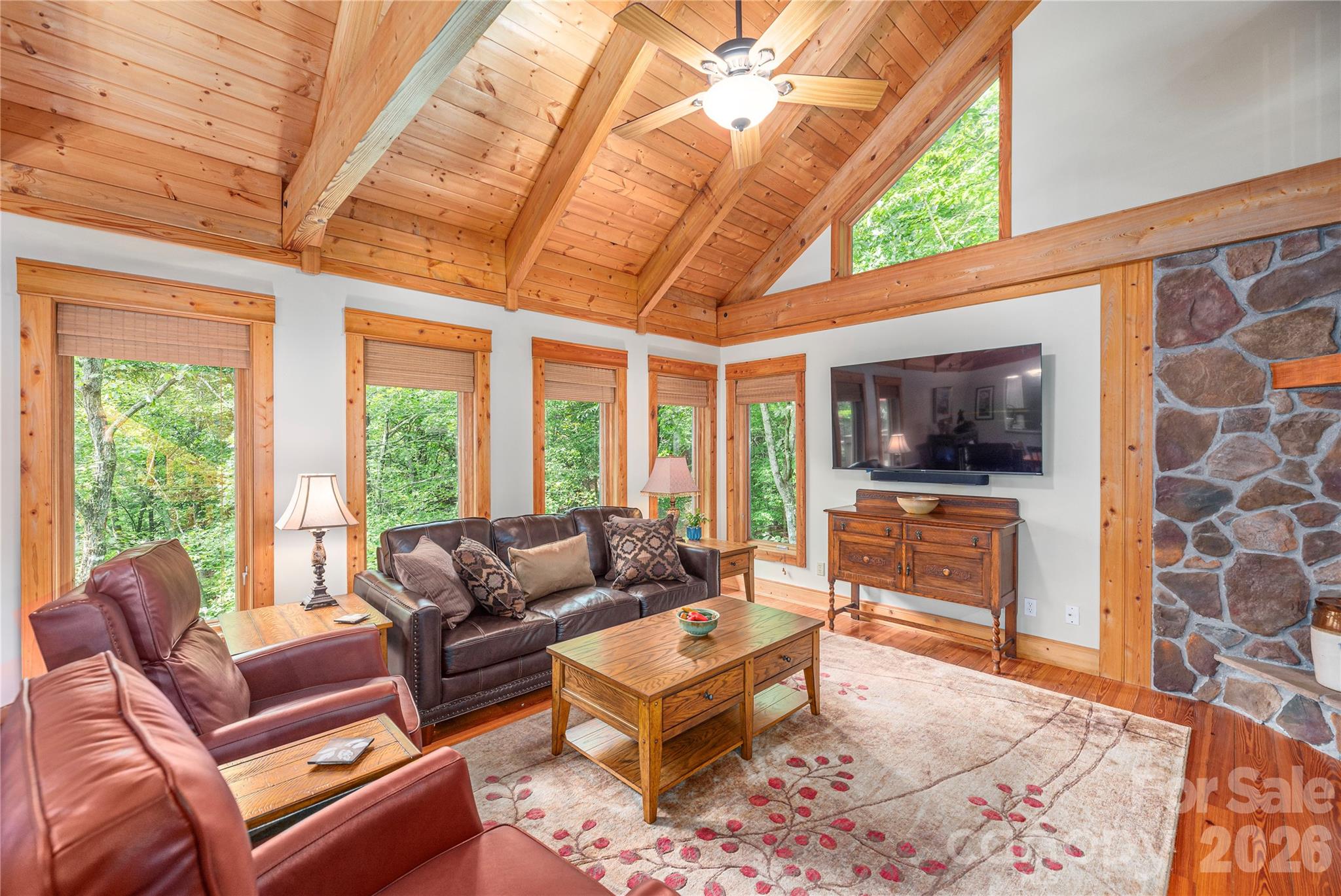 116 Ivy Road Mills River, NC 28759 - Photo 12 of 45 a living room with furniture a flat screen tv and a floor to ceiling window