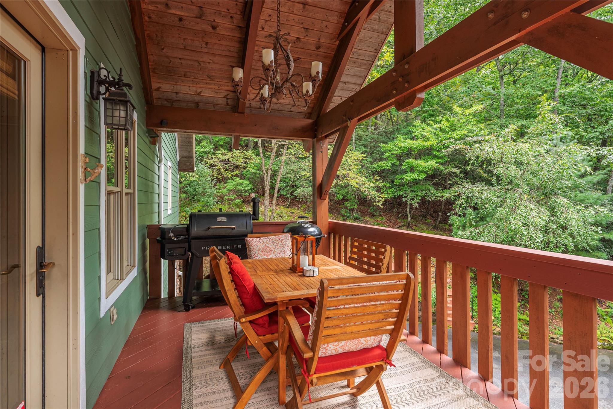 116 Ivy Road Mills River, NC 28759 - Photo 4 of 45 a view of a patio with table and chairs next to a yard