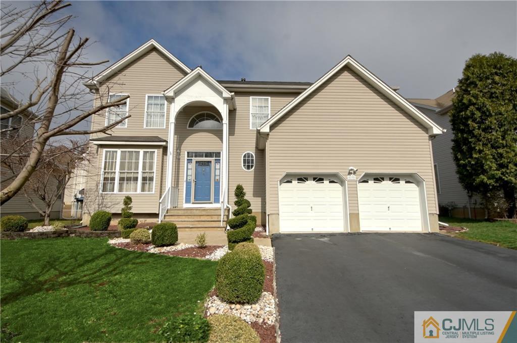 13 Timber Ridge Road North Brunswick, NJ 08902 - Photo 1 of 24 a front view of a house with a yard