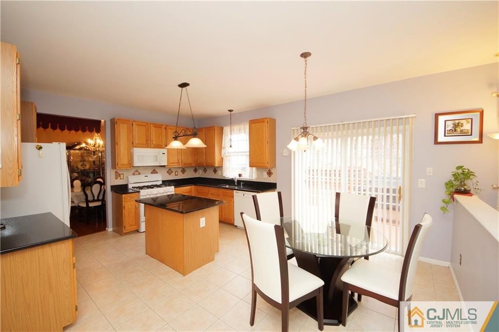 13 Timber Ridge Road North Brunswick, NJ 08902 - Photo 11 of 24 a dining table chairs and a counter top space