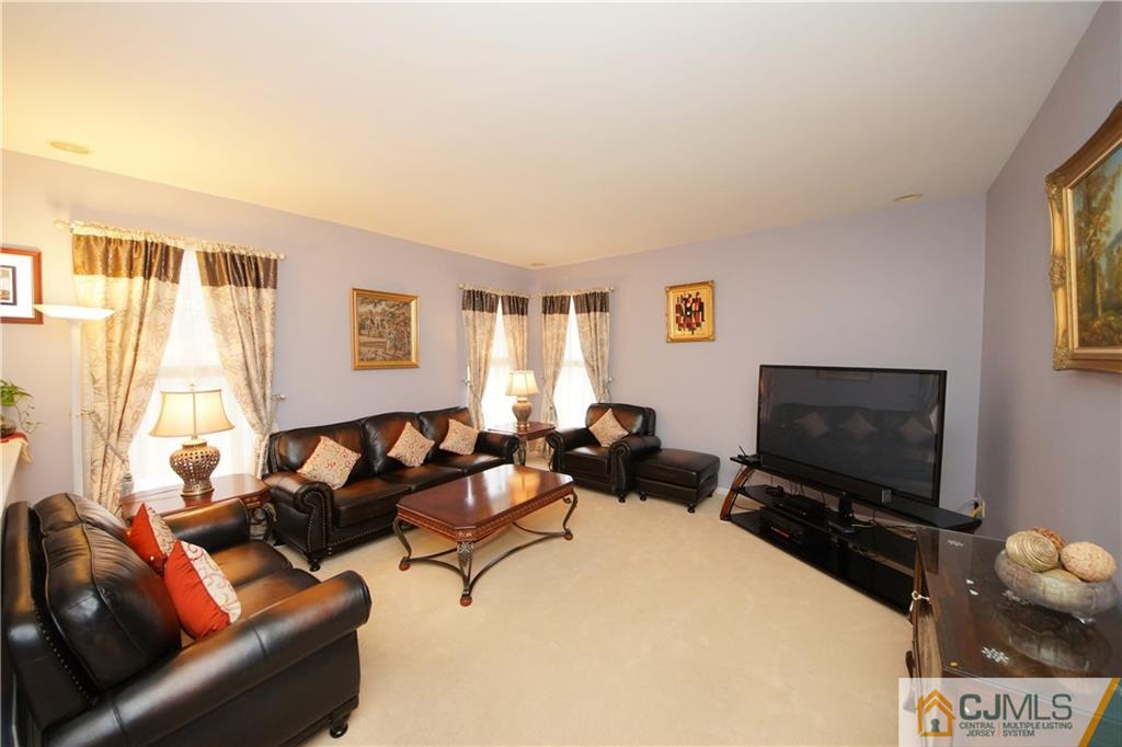 13 Timber Ridge Road North Brunswick, NJ 08902 - Photo 12 of 24 a living room with furniture and a flat screen tv