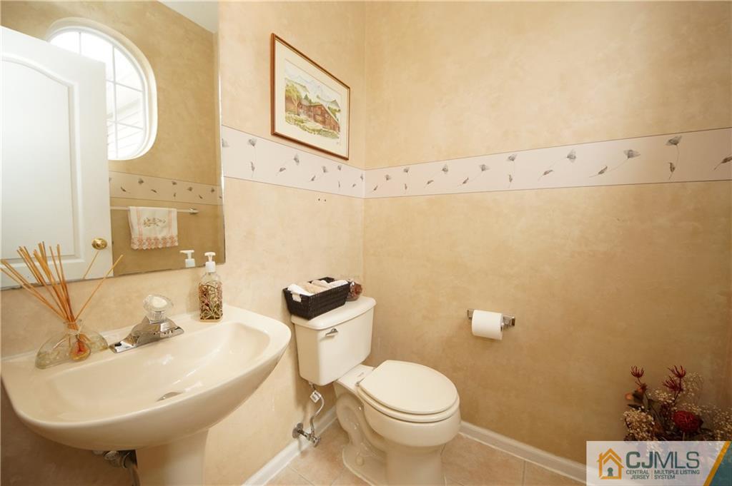13 Timber Ridge Road North Brunswick, NJ 08902 - Photo 14 of 24 a bathroom with a sink and mirror with toilet