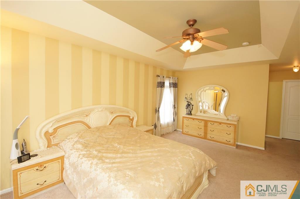 13 Timber Ridge Road North Brunswick, NJ 08902 - Photo 17 of 24 a bedroom with a bed and a chandelier