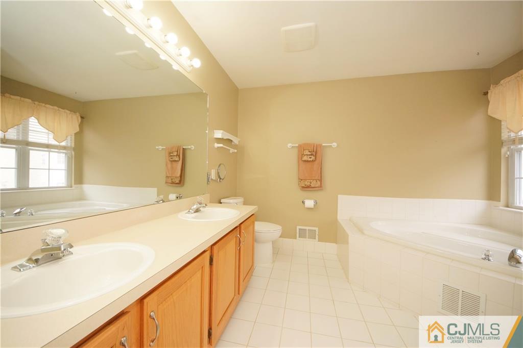 13 Timber Ridge Road North Brunswick, NJ 08902 - Photo 18 of 24 a spacious bathroom with a tub sink and mirror