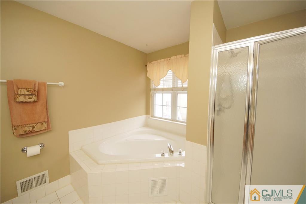 13 Timber Ridge Road North Brunswick, NJ 08902 - Photo 19 of 24 a bathroom with a bathtub
