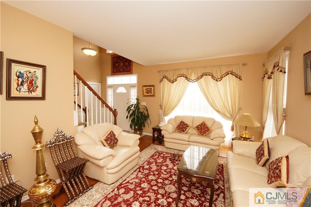 13 Timber Ridge Road North Brunswick, NJ 08902 - Photo 6 of 24 a living room with furniture and a wooden floor