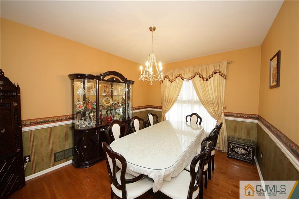 13 Timber Ridge Road North Brunswick, NJ 08902 - Photo 8 of 24 a view of a dining room with furniture and chandelier