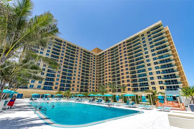 a view of a patio with a table and chairs under an umbrella