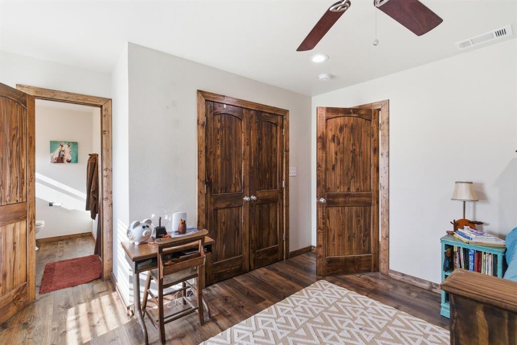 187 County Road 4195 Decatur, TX 76234 - Photo 25 of 40 a bedroom with furniture closet and a rug