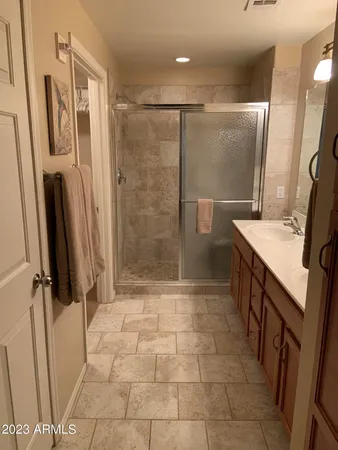 a bathroom with a sink a mirror and shower