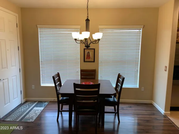 a dining room with furniture and wooden floor