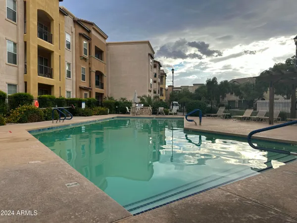 a view of a lake with a building and a big yard