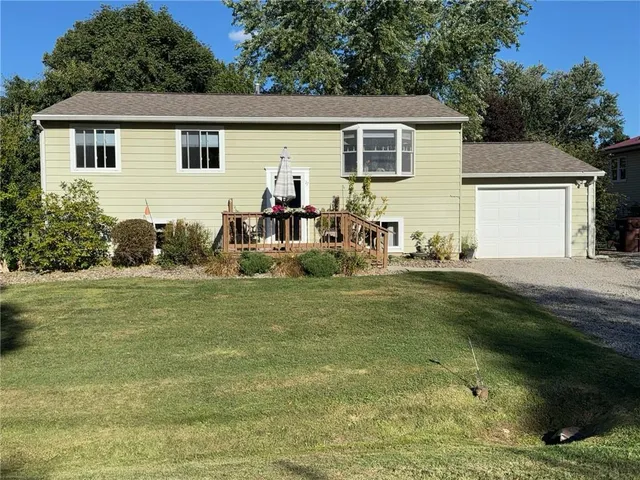 a backyard of a house with table and chairs