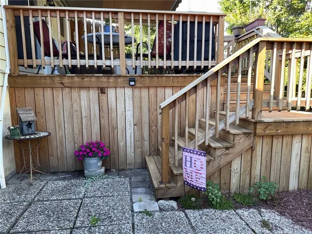 a view of staircase with railing and a potted plant