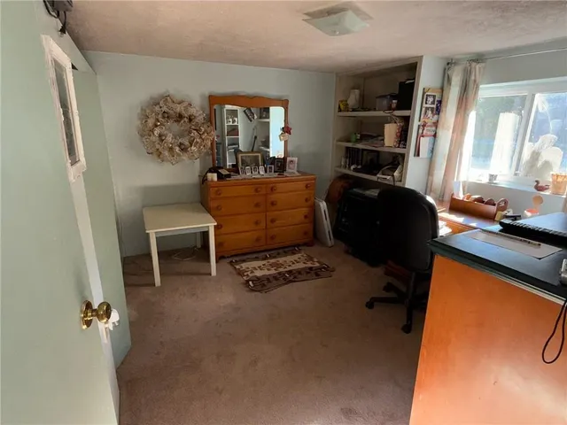 a bedroom with furniture and a window
