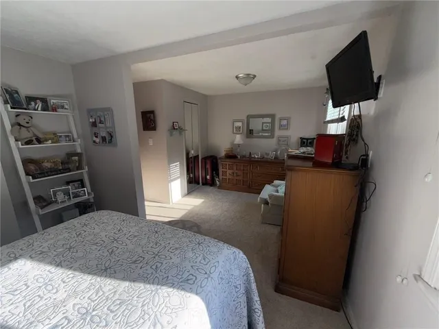 a bedroom with furniture and a flat screen tv