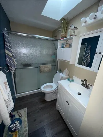 a bathroom with a double vanity sink toilet and a mirror