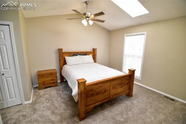 a bedroom with a bed and a ceiling fan