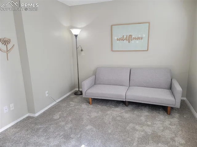 a living room with furniture and a wall painting