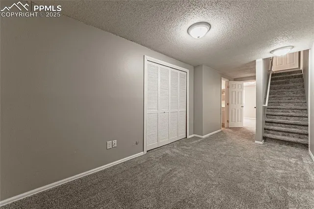 an empty room with a hallway and stairs