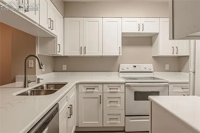 a kitchen with cabinets appliances a sink and a counter top