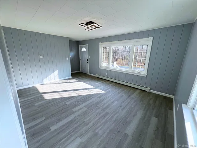 a large kitchen with a refrigerator a sink dishwasher a dining table and chairs