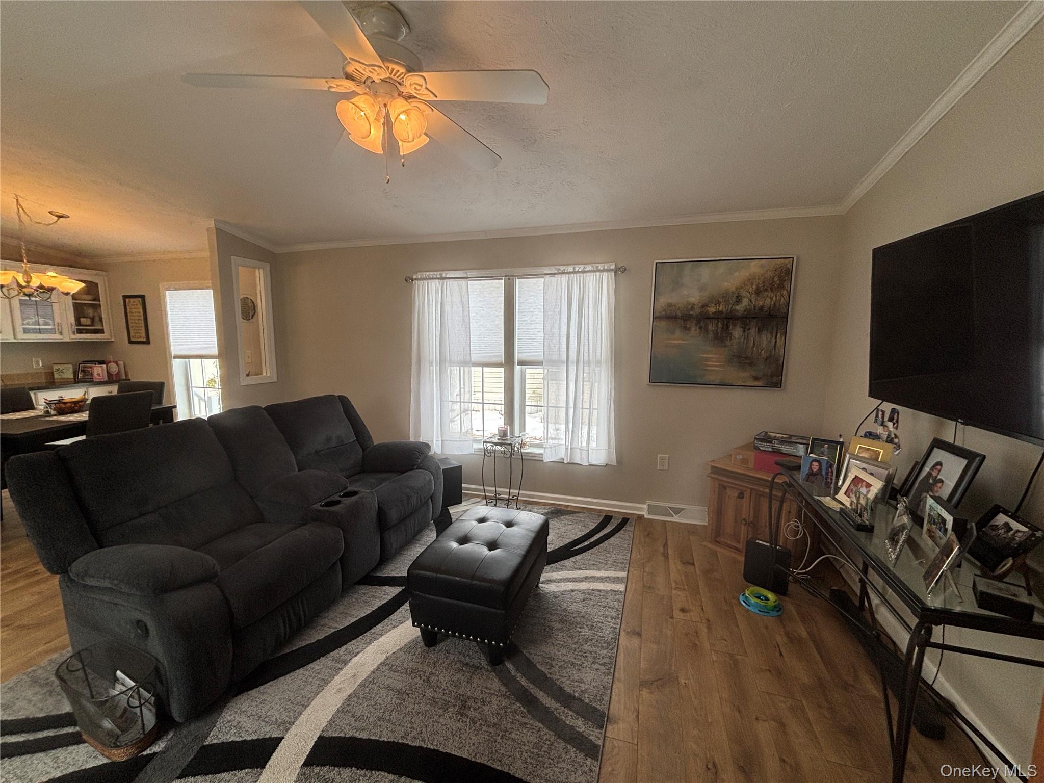 1661 Old Country Road, Unit 69 Riverhead, NY 11901 - Photo 15 of 37 a living room with furniture a window and a flat screen tv